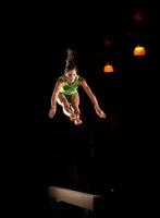 sprong in de lucht van gymnast hoog boven de evenwichtsbalk foto