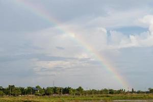 regenboog en bewolkt over het landelijke dorp. foto