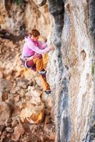 jonge vrouwelijke bergbeklimmer op klif
