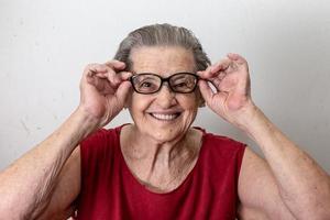 vrolijke senior dame in glazen lachen foto