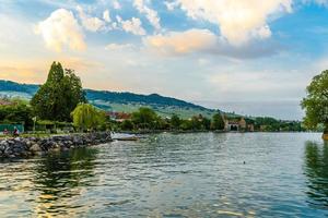 zonsondergang met reflecties op het prachtige meer van Genève, zwitserland foto