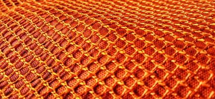 goud oranje honingraat net patronen backgrpund. synthetische honingraatstructuur stof achtergrondontwerp. beschikbaar voor tekst. geschikt voor poster, backdrop, presentatie, behang, reclame, etc. foto