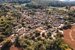 luchtfoto van een lokaal landelijk dorp in de vallei op het platteland tussen het tropische regenwoud foto