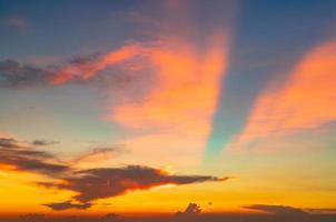 mooie zonsonderganghemel. oranje en blauwe zonsonderganghemel met mooi patroon van wolken. oranje, rode en blauwe wolken in de schemering. vrijheid en rustige achtergrond. schoonheid in de natuur. krachtige en spirituele scène. foto