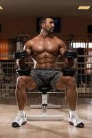 bodybuilder die zwaargewicht oefening voor schouders doet foto