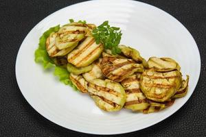 plakjes gegrilde aubergine geserveerd met basilicum foto