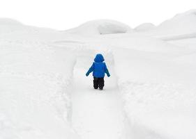 jongen wandelen door besneeuwde pad foto