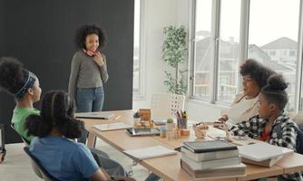 Afro-Amerikaanse studente stelt zichzelf zelfverzekerd voor in de klas. foto