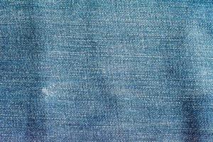 de blauwe spijkerbroek of blauwe denim schone textuur. foto