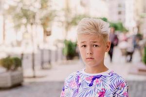 portret van schattige knappe blonde elf oude jongen verloren in de stad. opgroeien, jeugd, scheidingsconcept foto