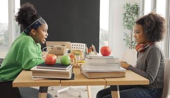 Afro-Amerikaanse studenten praten gelukkig terwijl ze delen met gedachten in de studeerkamer. foto