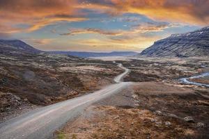 uitzicht op de weg te midden van vulkanisch landschap bij de oostfjorden tegen de dramatische lucht foto