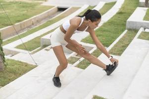 een jonge fitnessvrouw in sportkleding die traint in het stadspark, gezond en levensstijl. foto