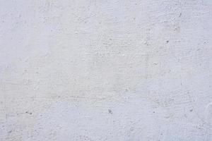 textuur van een betonnen muur met scheuren en krassen die als achtergrond kunnen worden gebruikt foto