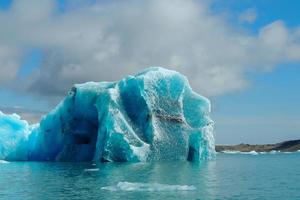 heldere helderblauwe ijsberg drijvend in het jokulsarlon meer blauw koud water in ijsland 45 foto