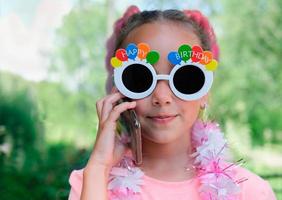 mooi Kaukasisch meisje met een zonnebril voor gelukkige verjaardag foto