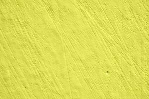 gouden muur of glanzende gele bladgoudfolie achtergrond, gouden papiertextuur, abstract cementoppervlak, betonpatroon, geverfd cement foto