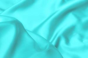 cyaan-blauwe satijnen stof textuur zachte achtergrond foto