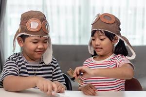 twee kinderen met vliegtuigen in handen foto