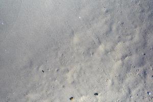 zand textuur. zandstrand voor achtergrond. bovenaanzicht foto