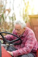 senior man od tractor