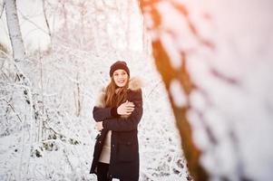 mooie brunette meisje in warme winterkleding. model op winterjas en zwarte hoed. foto