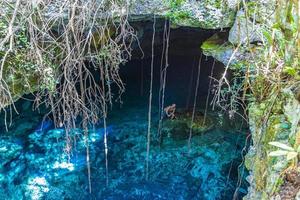 toeristische gids blauw turkoois water kalksteen grot sinkhole cenote mexico. foto