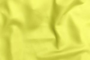 gele satijnen stof textuur zachte wazige achtergrond foto