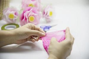 vrouw die mooie nylon bloem maakt - mensen met diy handgemaakte bloem concept foto