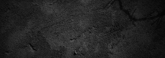 zwarte muur eng of donkergrijze ruwe korrelige steen textuur achtergrond. zwart beton voor achtergrond. foto