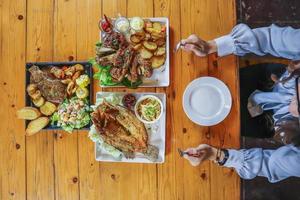 een verscheidenheid aan gerechten staat op tafel om familie- en vriendenbanketten op oudejaarsavond voor te bereiden. diverse ideeën voor het bereiden van voedsel voor familie- en vriendenfeesten tijdens de feestdagen. foto