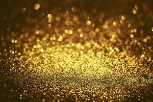 gouden glitter bokeh verlichting textuur wazig abstracte achtergrond voor verjaardag, jubileum, bruiloft, oudejaarsavond of kerst foto