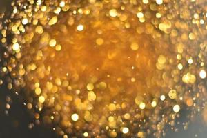 gouden glitter bokeh verlichting textuur wazig abstracte achtergrond voor verjaardag, jubileum, bruiloft, oudejaarsavond of kerst foto