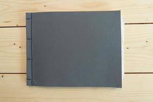 klassiek zwart notitieboekje op de houten tafel. foto