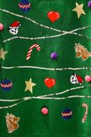 groene garen trui kerst ontwerp kat santa, eenhoorn, ster, ballon, zuurstok. foto