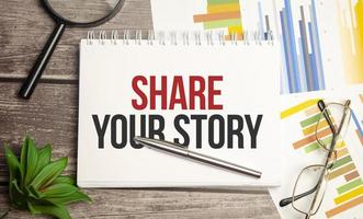 notitieblok met woord deel je verhaal en pen foto