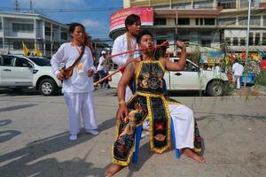 Korat, Thailand - 27 oktober niet-geïdentificeerde aanhanger van vegetarisch festival, persoon die de geesten van goden uitnodigt om hun lichaam te bezitten op 16 oktober 2015 in Korat, Thailand foto