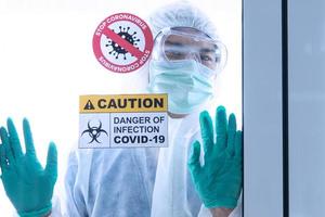 covid-19, corona virus uitbraak quarantaine epidemie verspreiding en social distancing concept. Aziatische artsen dragen pbm met corona- of covid-19-patiëntinfectie in de quarantainekamer van het ziekenhuis foto