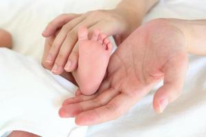 close-up baby's voeten met haar moeder, gezond met moeder voor nieuw familieconcept foto