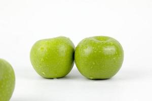 natuurlijke groene appel geïsoleerd op een witte achtergrond, met waterdruppels op de schillen foto