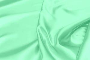 groene satijnen stof textuur zachte wazige achtergrond foto