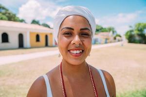 gelukkige braziliaanse vrouw gekleed in traditionele bahiaans kostuum dansen in het historische centrum van porto seguro. focus op gezicht foto