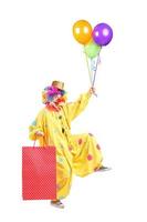 vrolijke clown met ballonnen en papieren zak