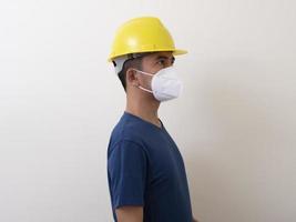 Aziatische industriële arbeiders dragen gele helmen, dragen beschermende maskers voor hun gezondheid foto