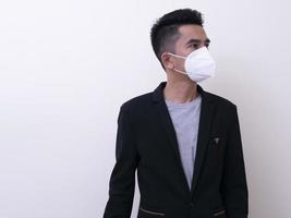 Aziatische jongeman en medisch masker om covid-19 te beschermen foto