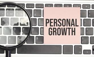 tekst persoonlijke groei concept op roze sticker op laptop toetsenbord foto