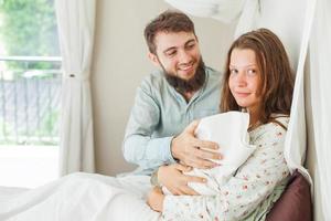 man steunt zijn vrouw na een bevalling