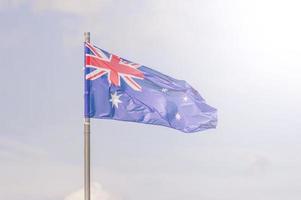 de nationale vlag van australië wappert over de blauwe lucht. zacht getint. foto