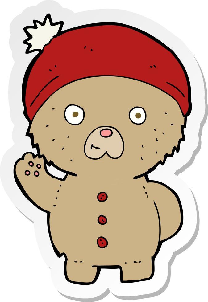 sticker van een cartoon zwaaiende teddybeer in wintermuts vector