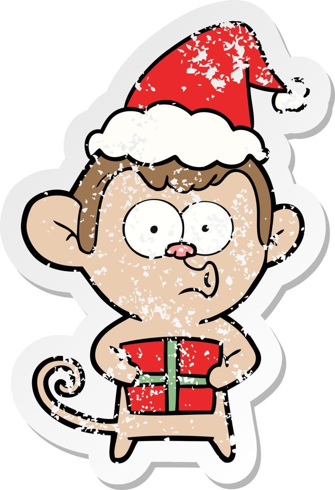 verontruste sticker cartoon van een kerstaap met een kerstmuts vector